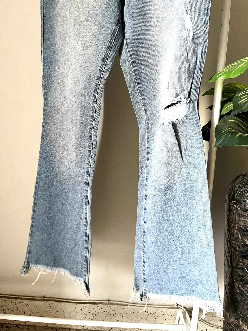 Blue bell-bottom ripped denim 